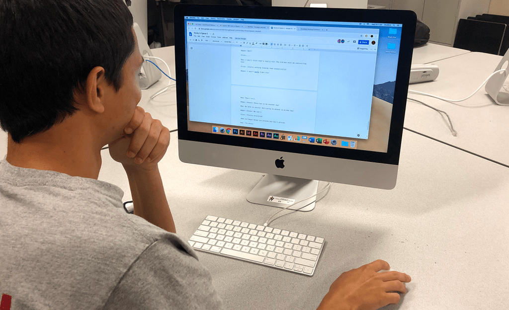 Max collaborating with the team while writing the movie script.