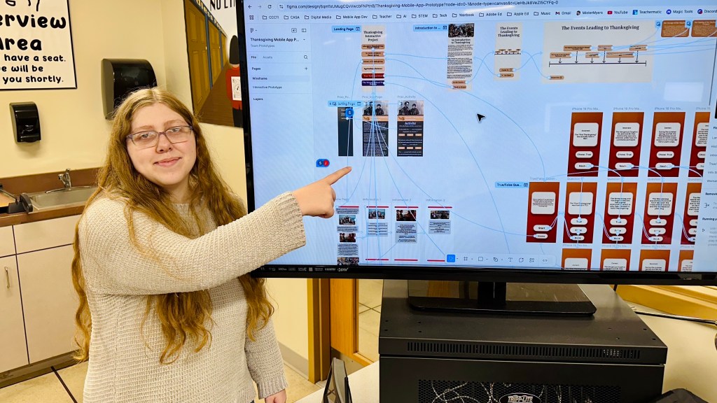 student showing the mobile app prototype project
